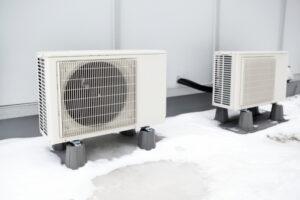 Mini-split heating and air conditioning system outdoor condenser units. A modern heat pump, this unit heats a house in winter and cools in the summer. This type of system eliminates ductwork which is a primary source of inefficiency in a conventional system making this about 30% more efficient. These outdoor units are connected directly to indoor evaporators.